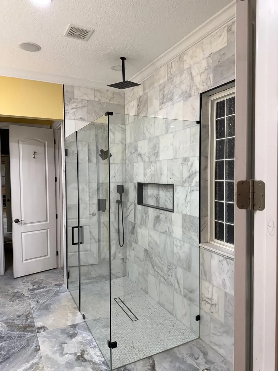 Marble-look tile shower installation by Braga Remodeling in Jacksonville, FL